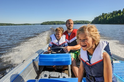 Father and children in life jackets